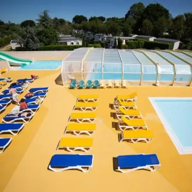 Piscine avec toboggan et transats au Camping de La Plage - 29