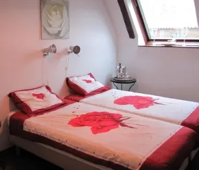 Chambre twin avec lits superposés et couvre-lits roses Le Clos de Banes