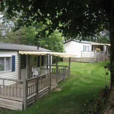 Mobil Home 3 Chambres - 6 personnes - Le Clos de banes : extérieur avec véranda et pelouse