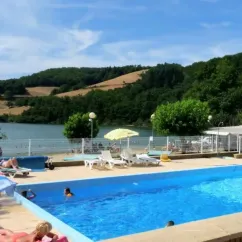Piscine extérieure avec chaises longues et parasols au Camping La Romiguière