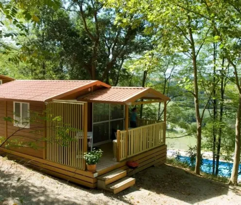Cottage 2CH - 5P - Camping Le Bourdieu : extérieur avec véranda et piscine