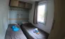Mobil Home Verdon 2CH - 4P - Camping Paradis Le Ruou, chambre avec deux lits et rangements