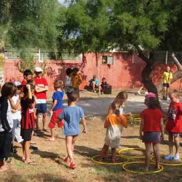 Enfants font des jeux avec des anneaux jaunes à Camping Cap Agathois