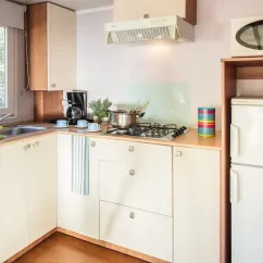 Cuisine du mobil home avec plancha, réfrigérateur et évier, Le Soleil des Landes