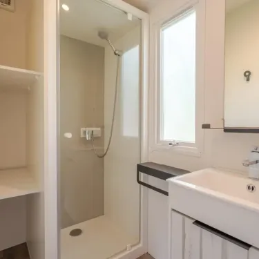 Salle de bain avec douche, lavabo, miroir, Camping Le Paradis