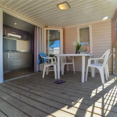 Terrasse du mobil home Hibiscus avec table, chaises, cuisine ouverte