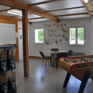 Salle des enfants du Camping Les Rives d'Auzon avec table de football et machines à bonbons