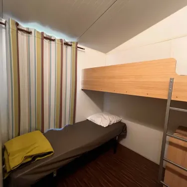 Chambre avec lit simple et lit superposé dans le camping Paradis Family