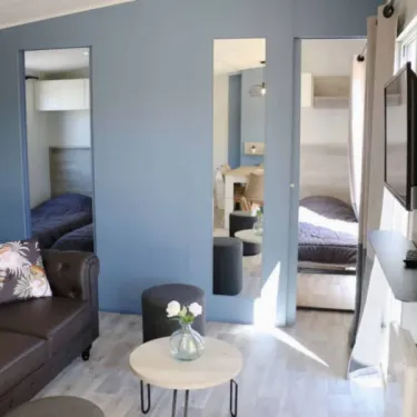 Mobil Home Tahiti Premium 3 Chambres 6 Personnes SPA - Landrezac Plage : salon avec canapé et miroirs