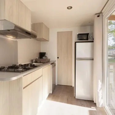 Cuisine du mobil-home MH Premium 2CH – 4P - Camping Paradis Albret, réfrigérateur et four