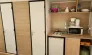 Tithome 2 Chambres 4 Personnes Sans Sanitaires - Camping des Bastides : cuisine compacte avec réfrigérateur, four à gaz et micro-ondes.