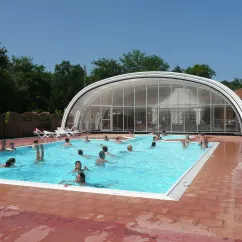 Piscine couverte avec personnes nageant au Camping Lou Puntaou