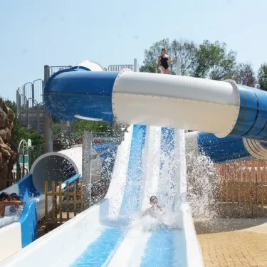Enfant montant un toboggan aquatique au Camping Antipolis