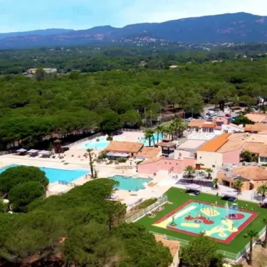 Aerial view of camping area with pools, playgrounds, and buildings