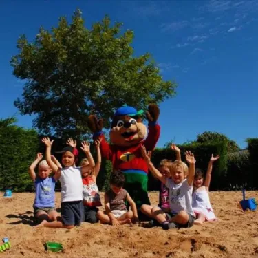 Enfants avec mascotte sur plage Camping Les Ilates