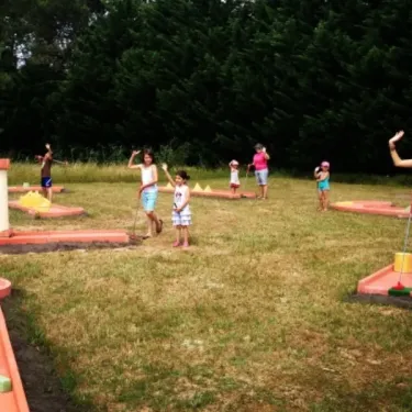 Enfants jouant au mini-golf dans le parc du Camping Pipiou