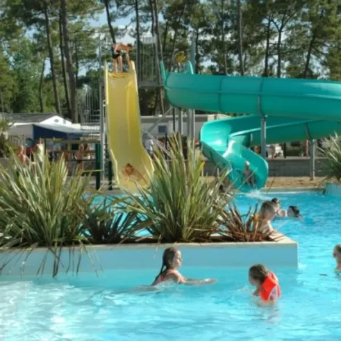 Enfants dans la piscine avec des toboggans à Camping Le California