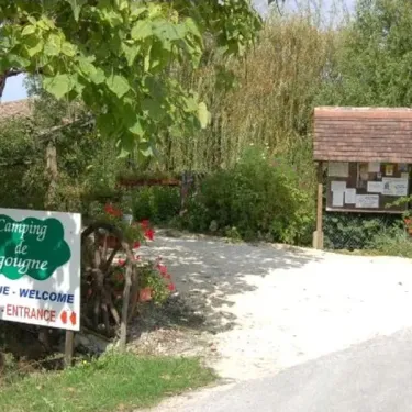 Entrée du Camping de Bergougne avec panneau d'accueil et signalétique bilingue.