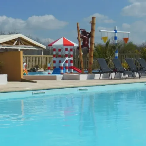 Piscine avec toboggan et chaises longues au Camping La Baie Dorée