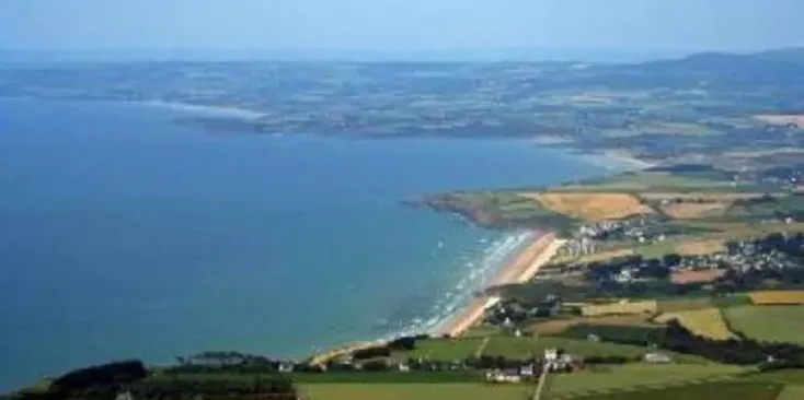 Vue aérienne du Camping Pré de la Mer avec plage et océan en arrière-plan.