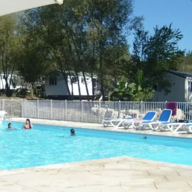 Mobile homes au bord d'une piscine, Camping Les Etangs du Plessac