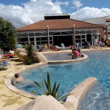 Camping La Boutinardière : piscine avec personnes détendues et structure en pierre