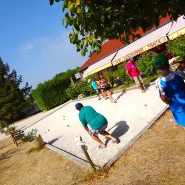 Camping Quercy Vacances : jeu de boules sur une aire en plein air sous un arbre.